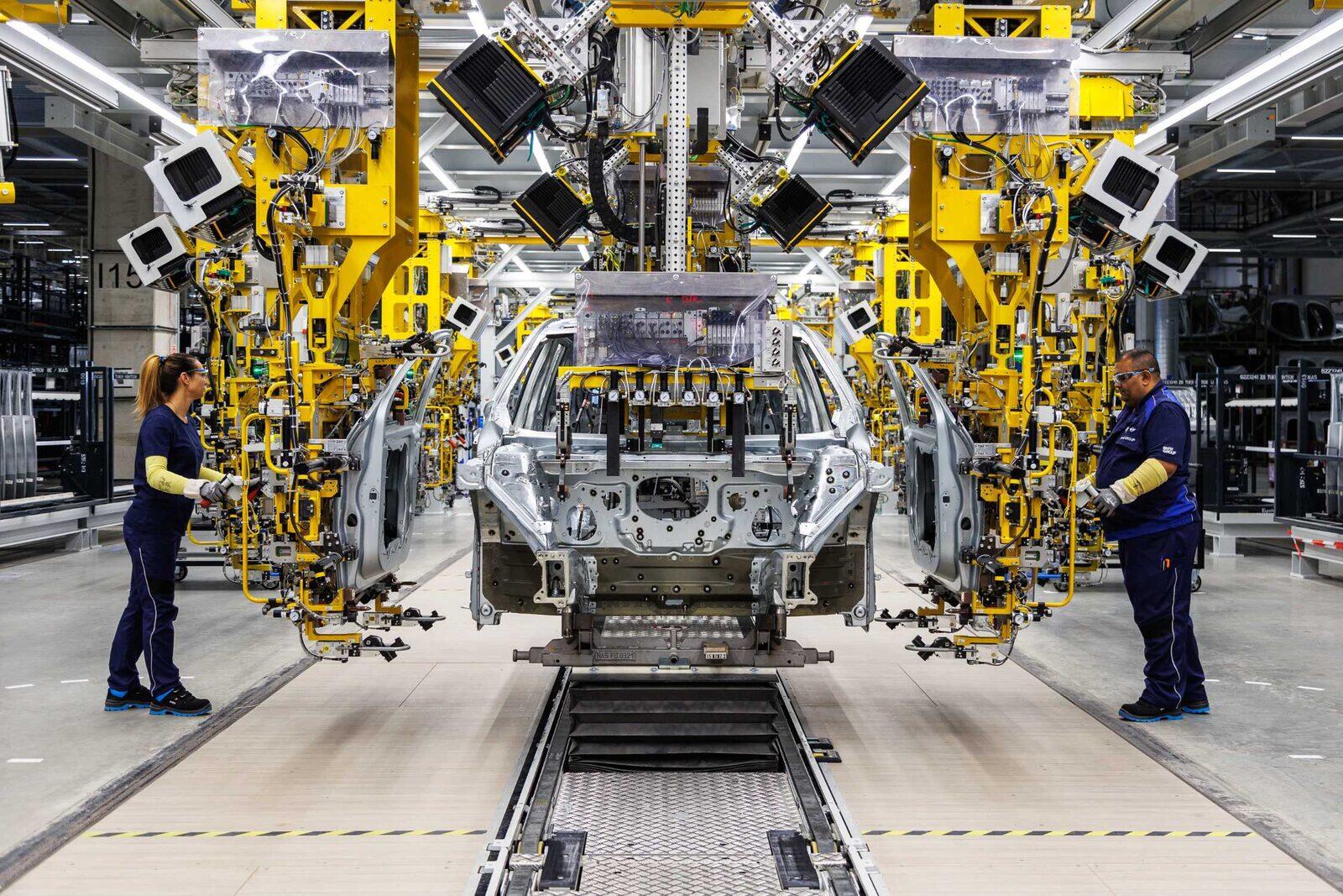 Karossmontering med medarbetare och robotar på BMW Group Plant Debrecen